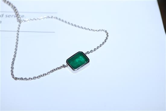 An 18ct white gold and solitaire emerald set pendant necklace, pendant 9mm.